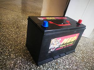 A car battery with a tiger on it.