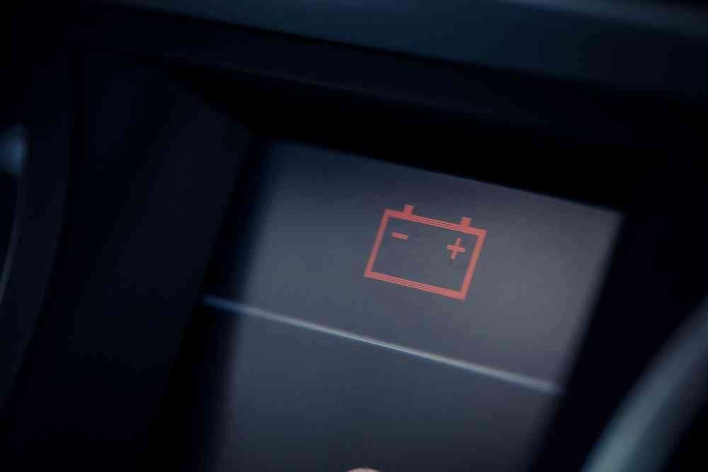 The dashboard of a car with a battery indicator.